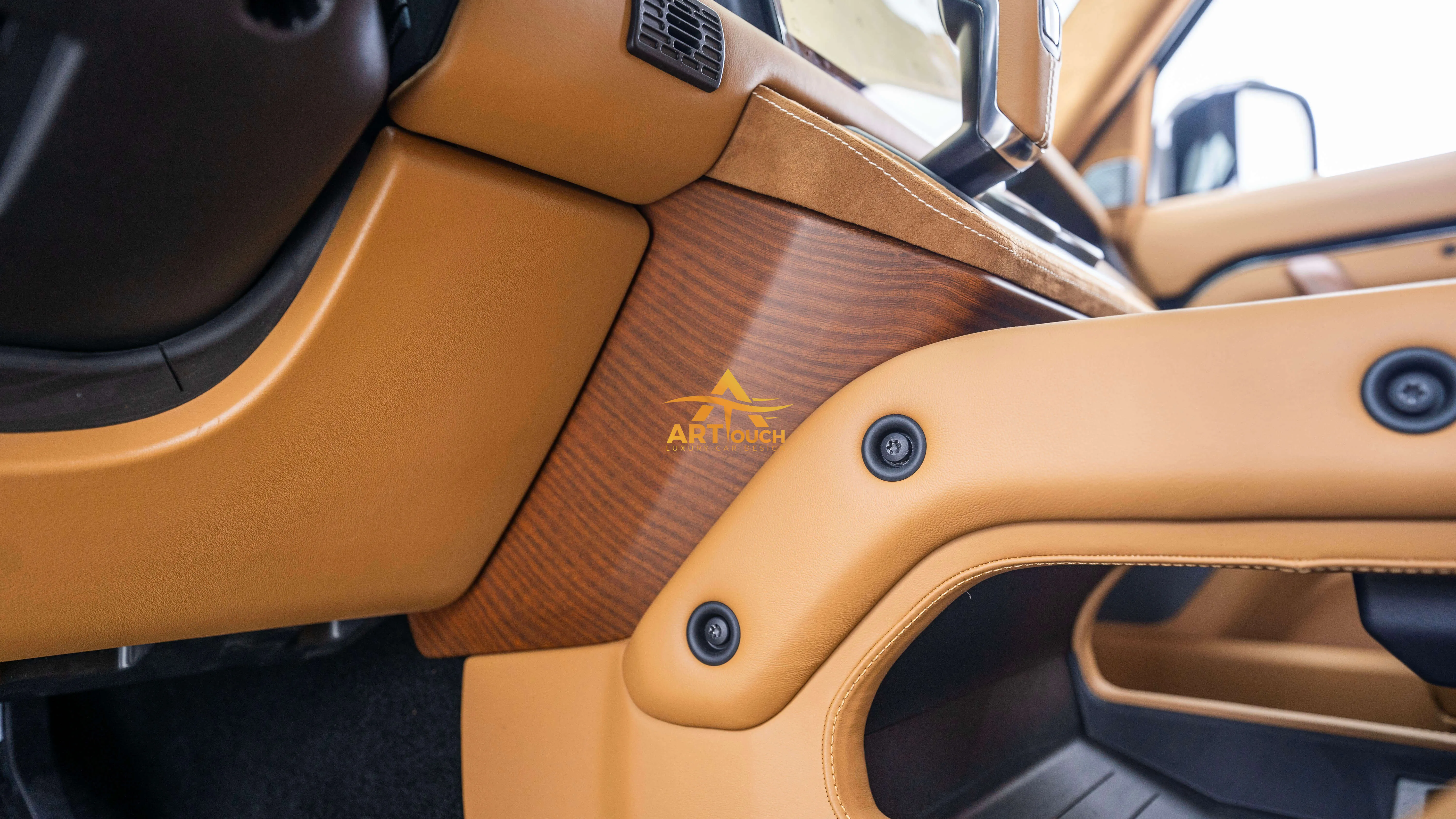 Bespoke Defender leather cabin. Premium Alcantara steering, custom gear knobs, and door panels crafted for a supreme luxury feel