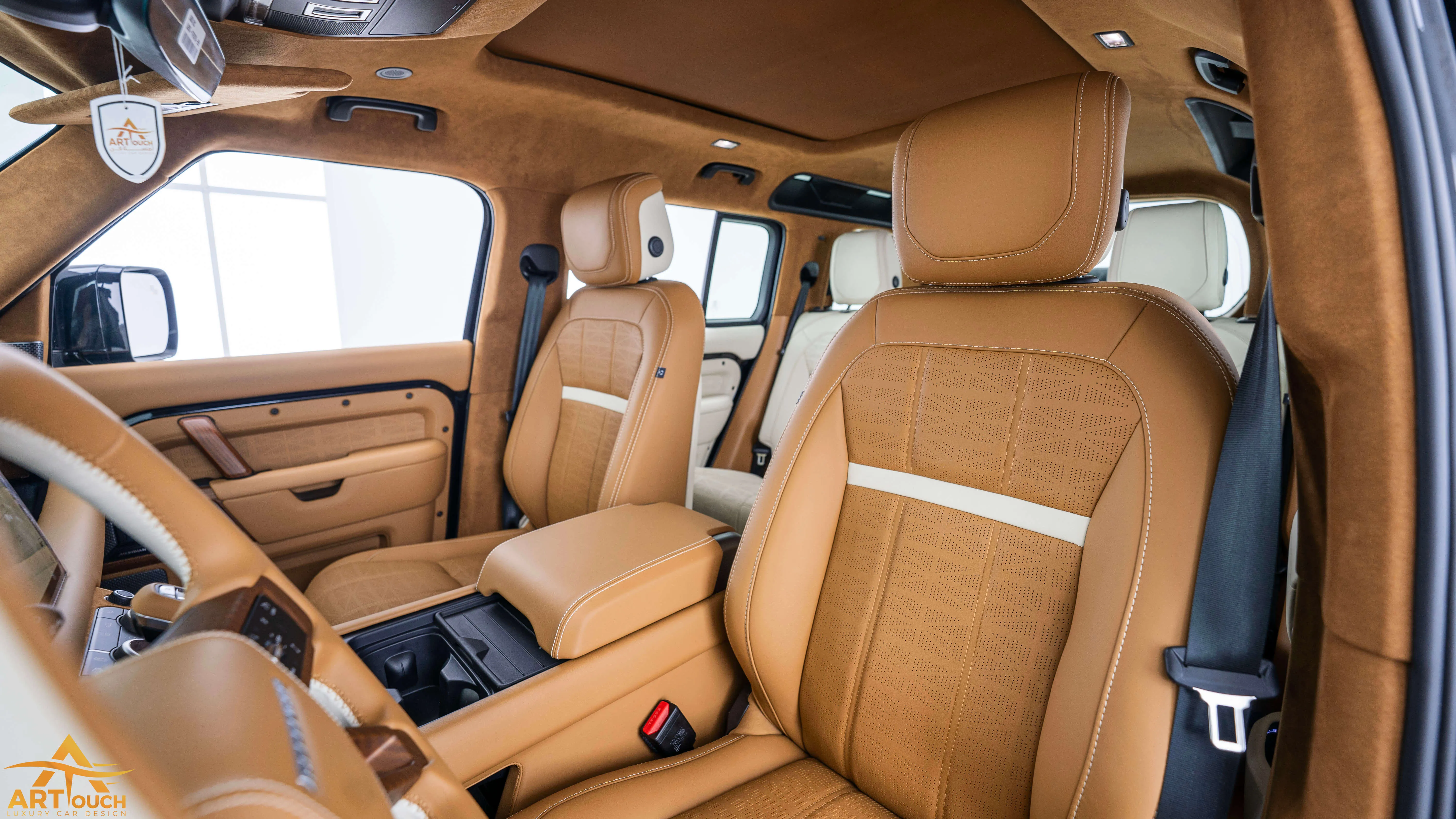 Bespoke Defender leather cabin. Premium Alcantara steering, custom gear knobs, and door panels crafted for a supreme luxury feel