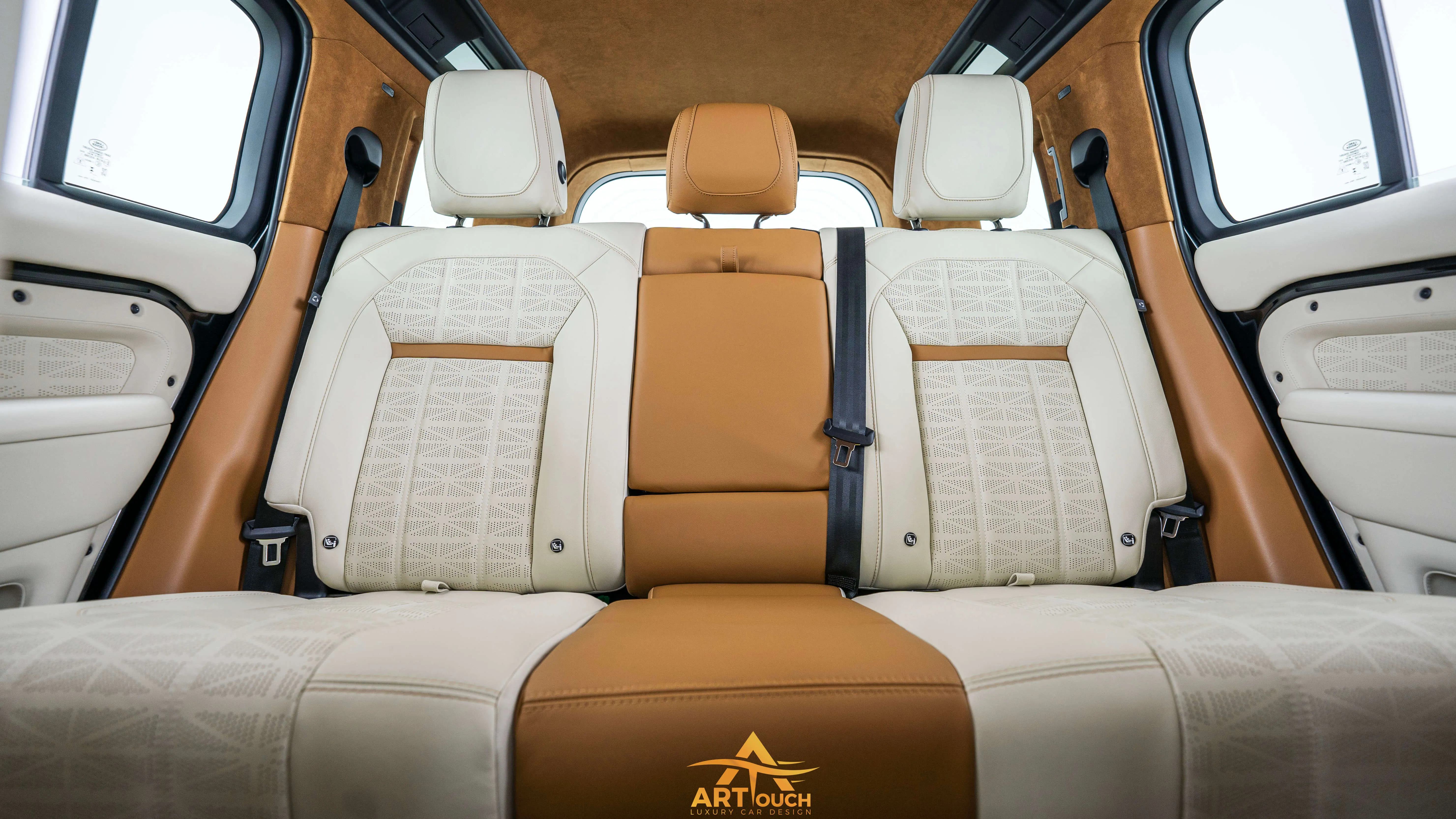 Bespoke Defender leather cabin. Premium Alcantara steering, custom gear knobs, and door panels crafted for a supreme luxury feel